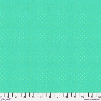 A light blue background with small white dots.