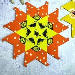 A Halloween-themed star-shaped paper craft with pumpkins and bats.