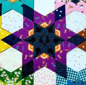 A vibrant geometric star pattern with various colorful textures.