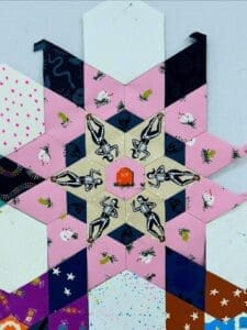 A colorful geometric star pattern with various designs and colors.